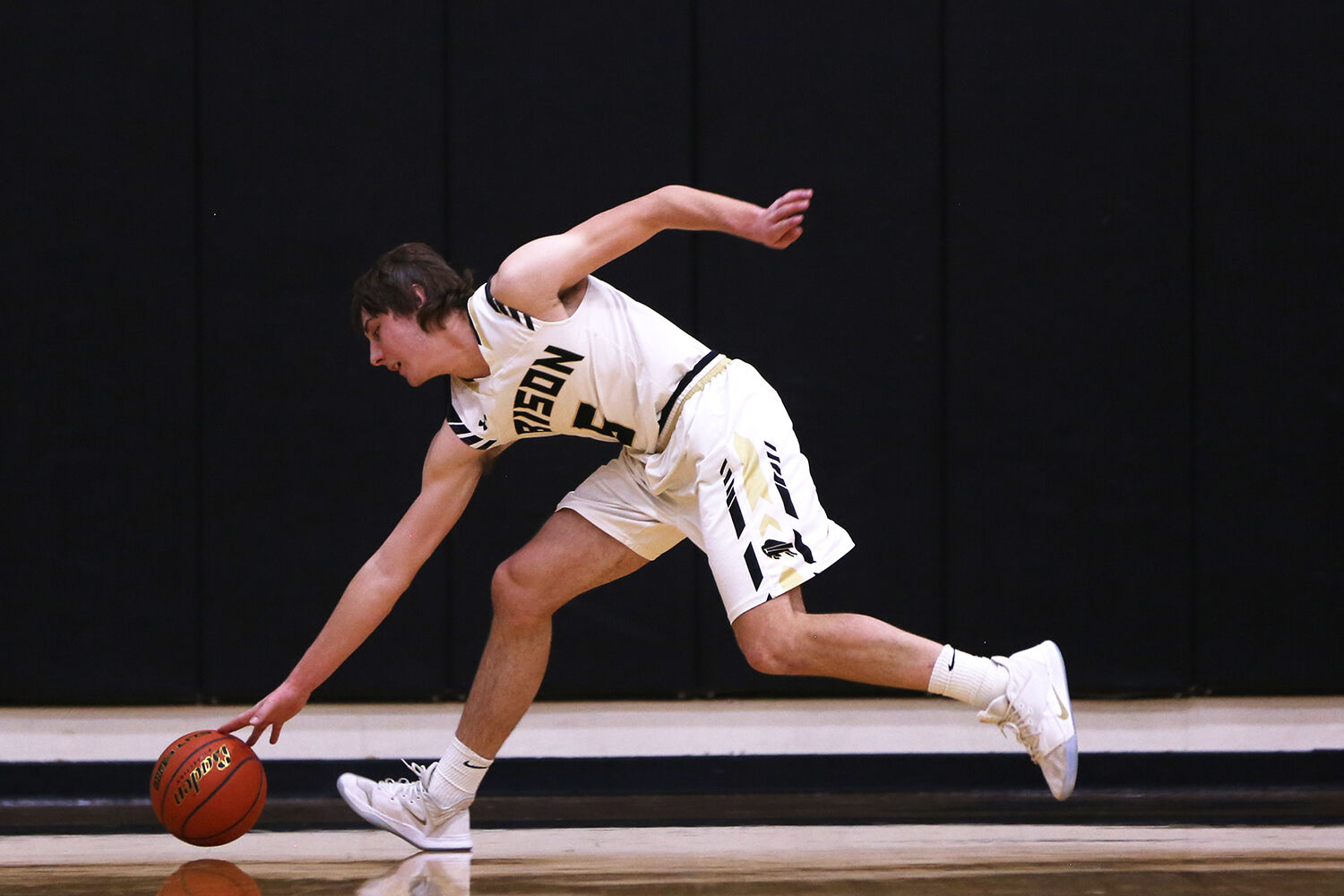 Hunter Stone dives to recover a ball before it goes out of bounds